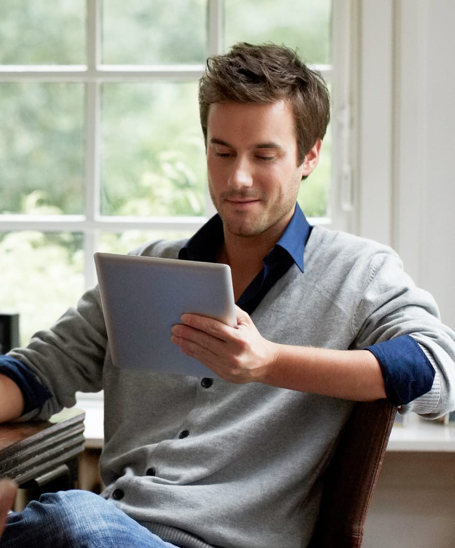 man looking at an ipad