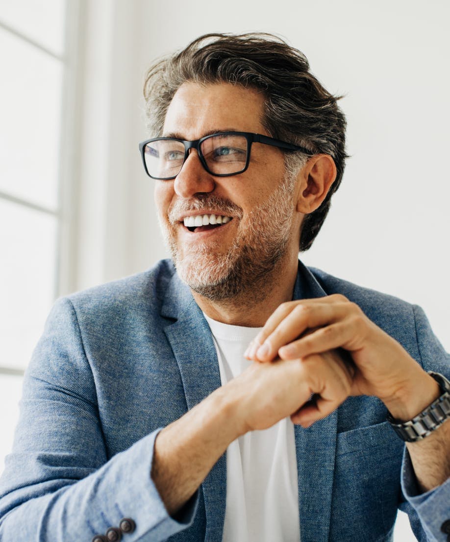 man with a salt and pepper beard smiling