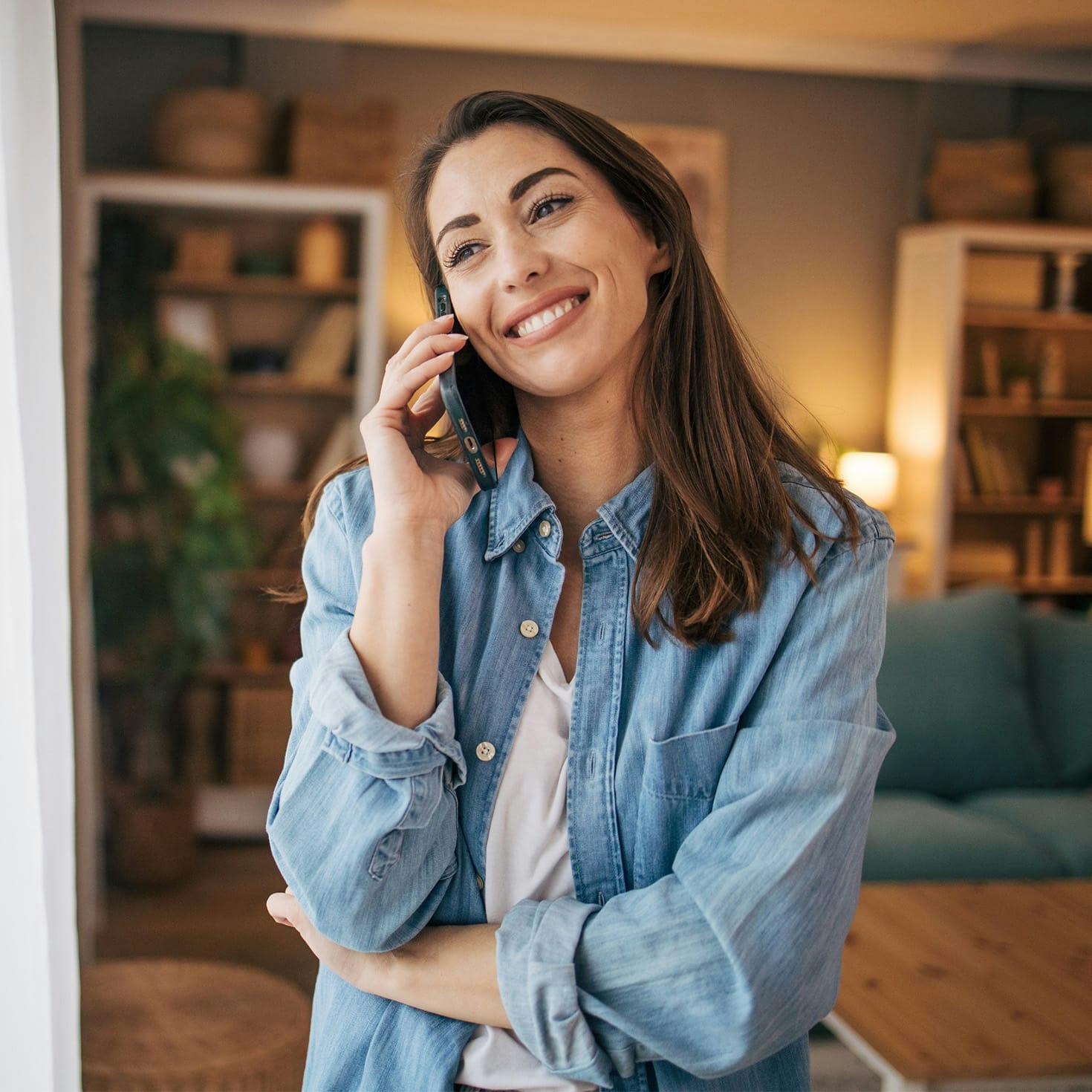 woman smiling, talking on the phone
