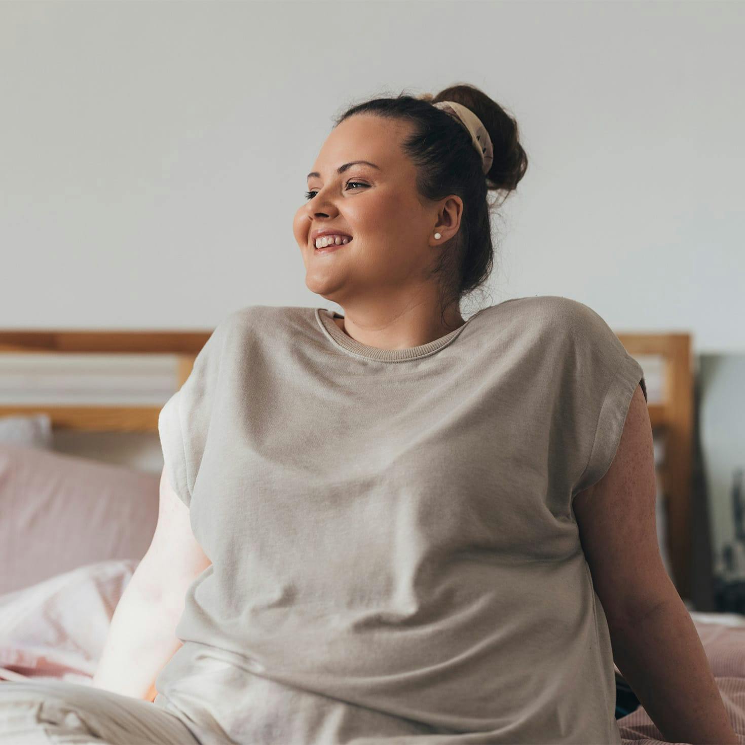 woman sitting on a bed