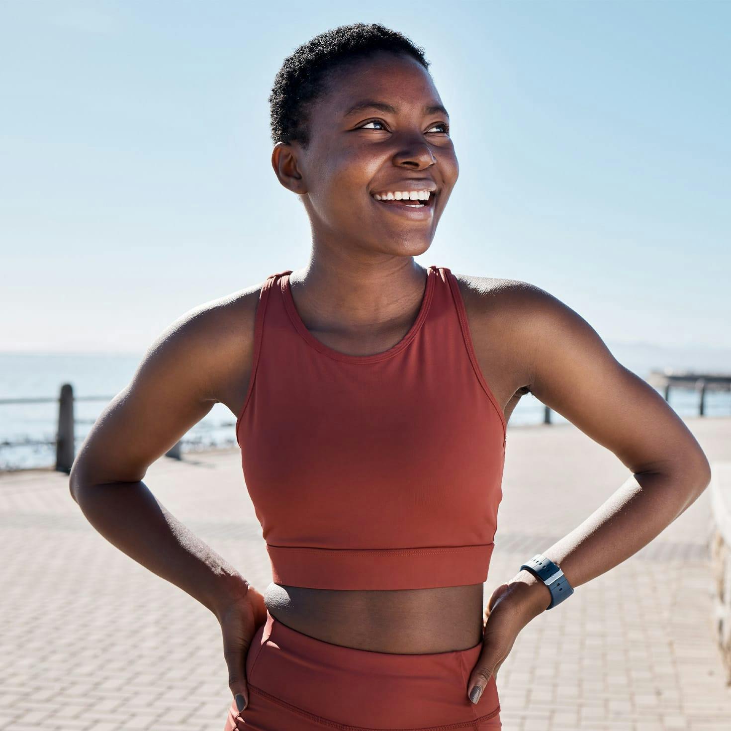 woman smiling, with her hands on her hips
