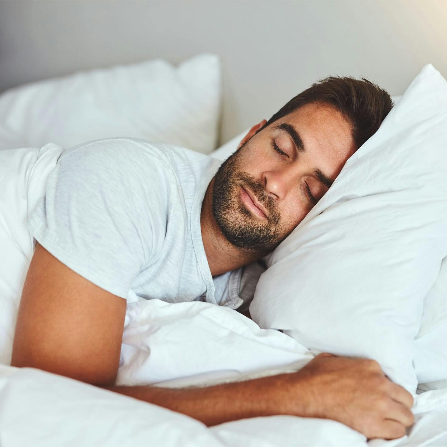 man sleeping in a bed