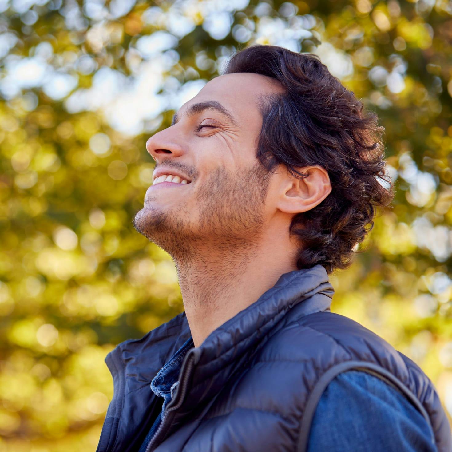 man smiling up at the sky