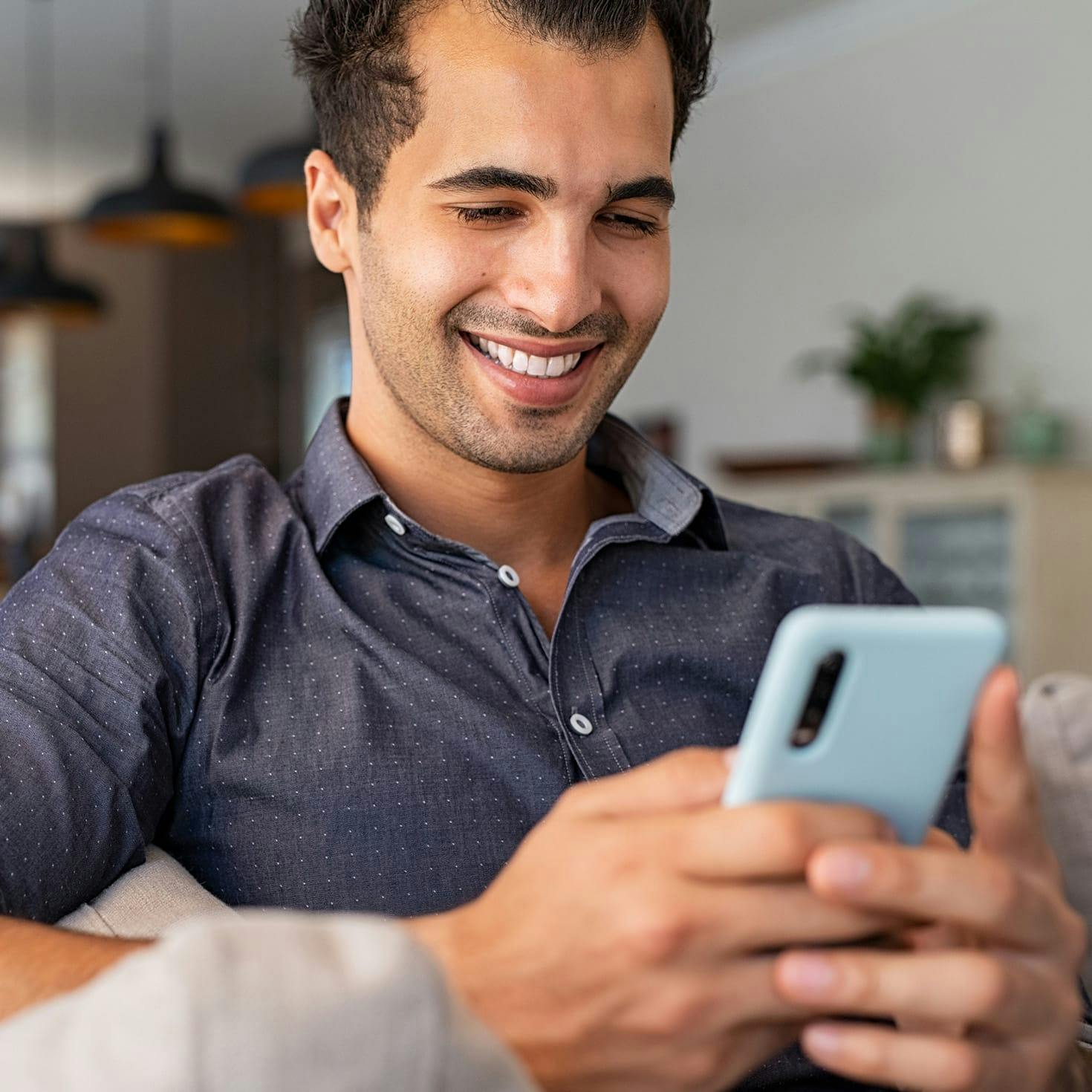 man smiling at his phone