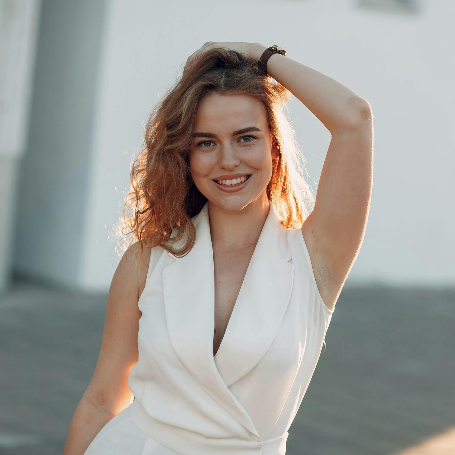 smiling woman with her hand on her head