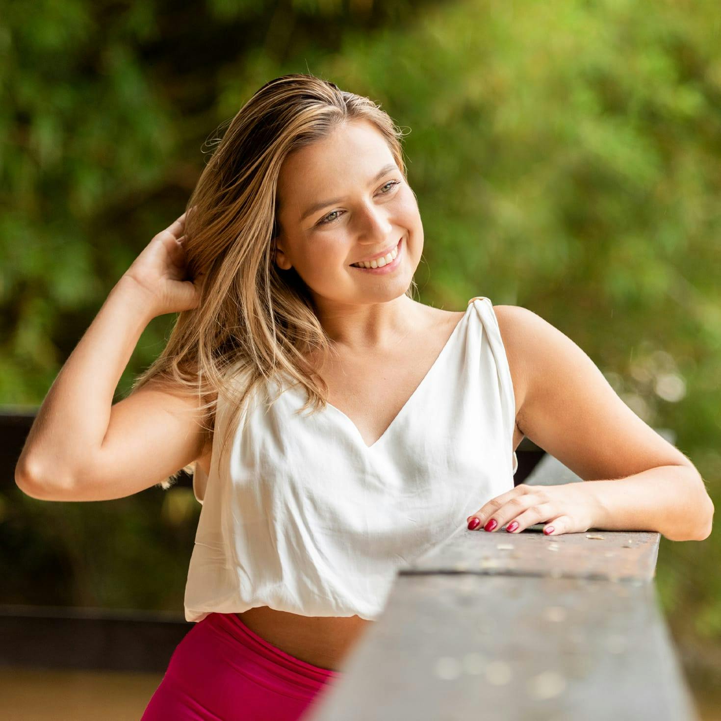 woman smiling, playing with her hair