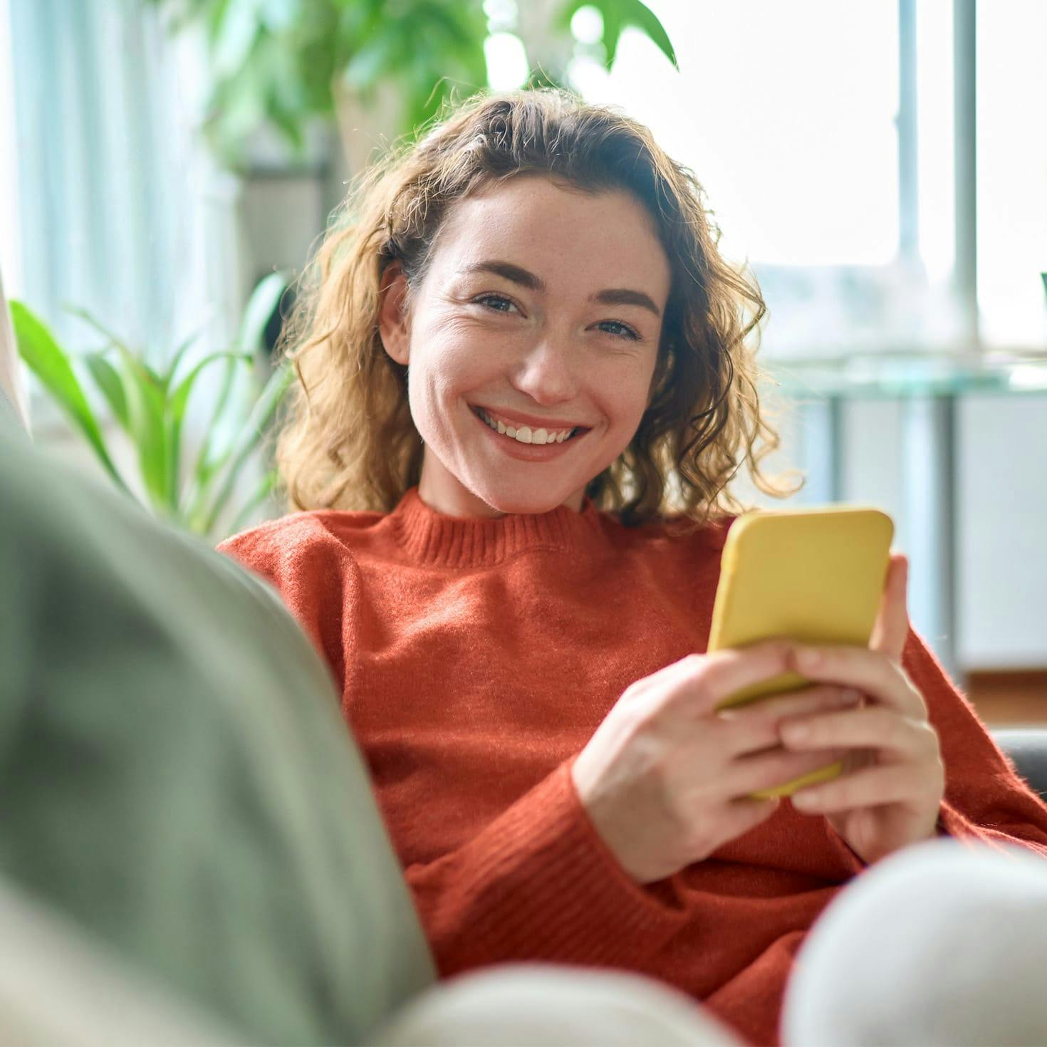 smiling woman looking at her phone