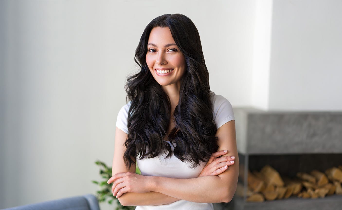 woman smiling, crossing her arms