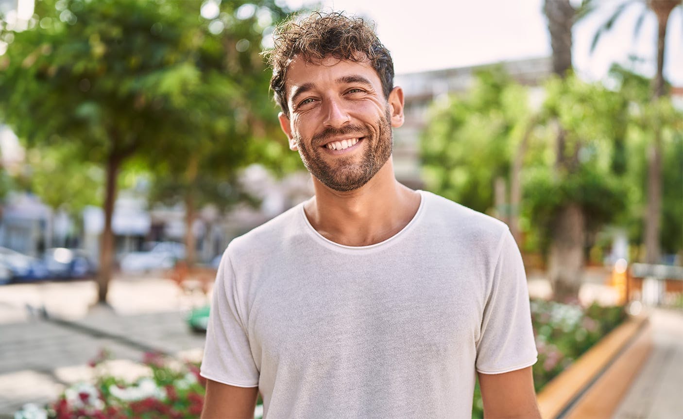 smiling man standing outside