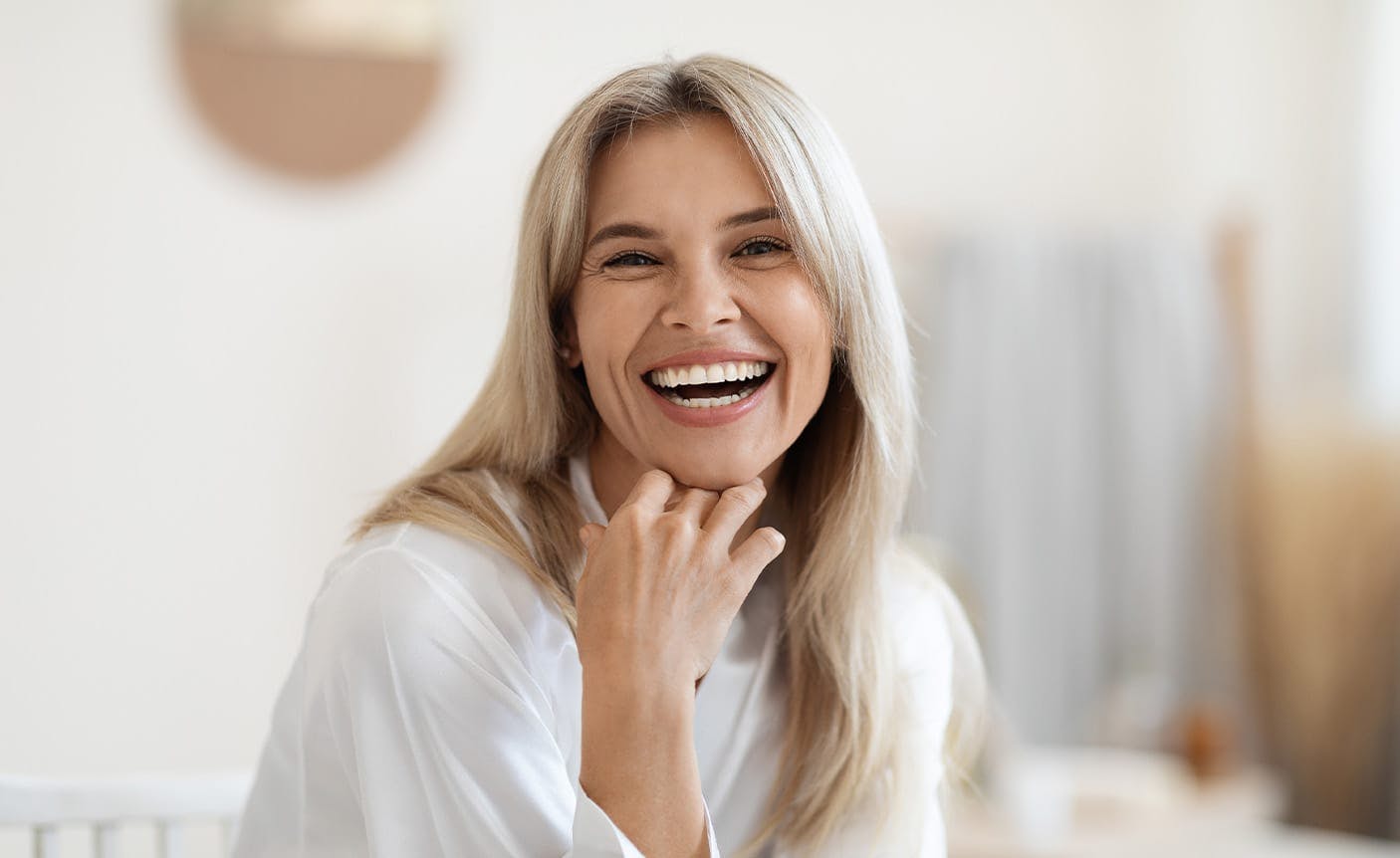smiling woman touching her chin