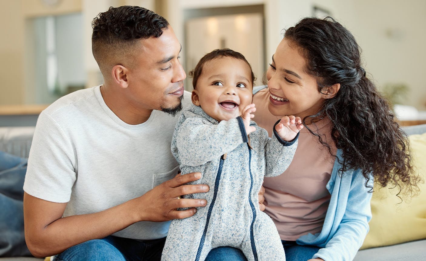 man and woman playing with a baby