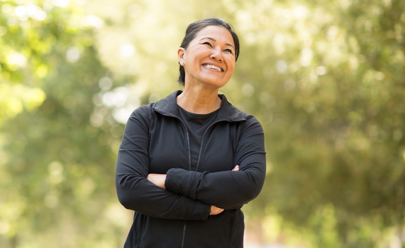 smiling woman crossing her arms