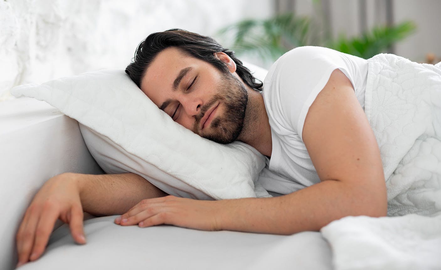 man sleeping in a bed