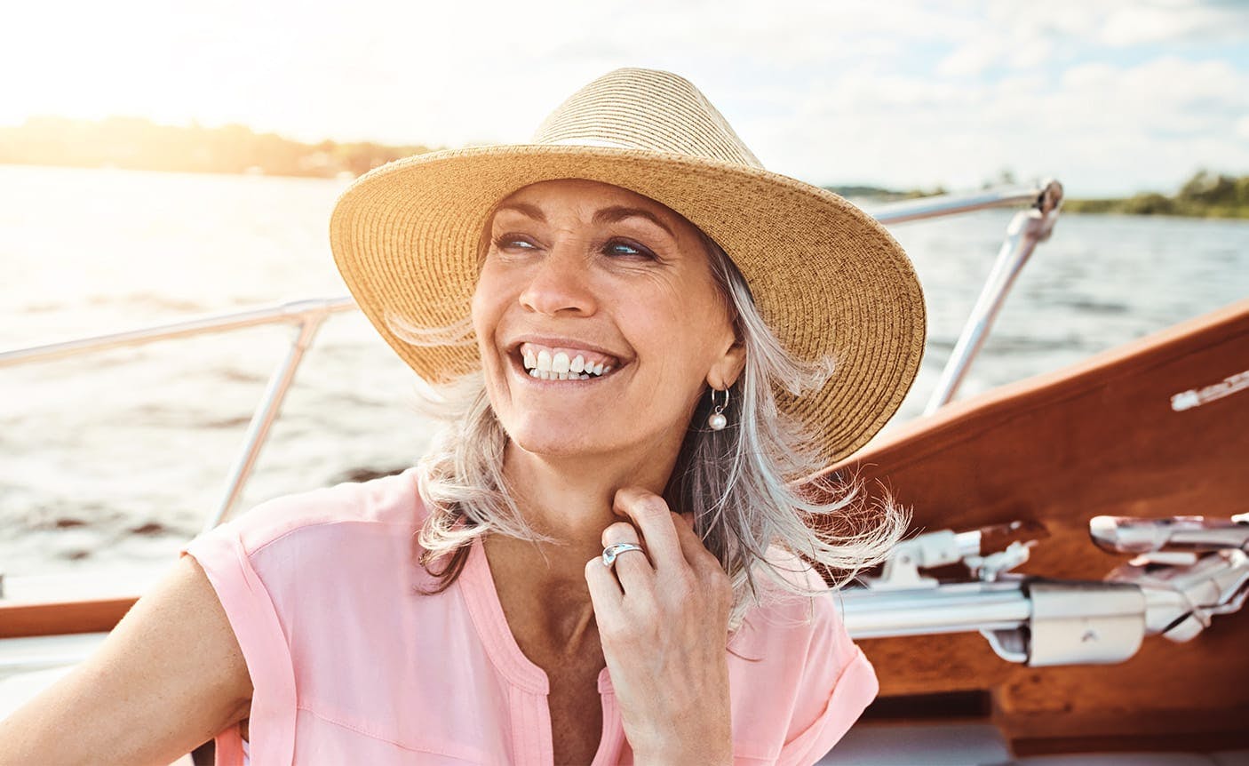 older woman on a boat, smiling