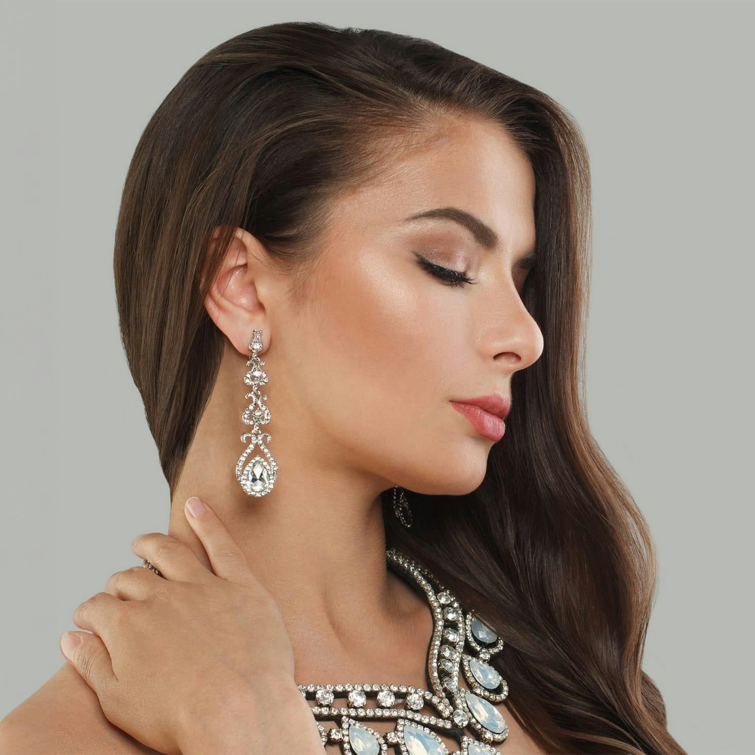 woman smiling, touching her hat on her head