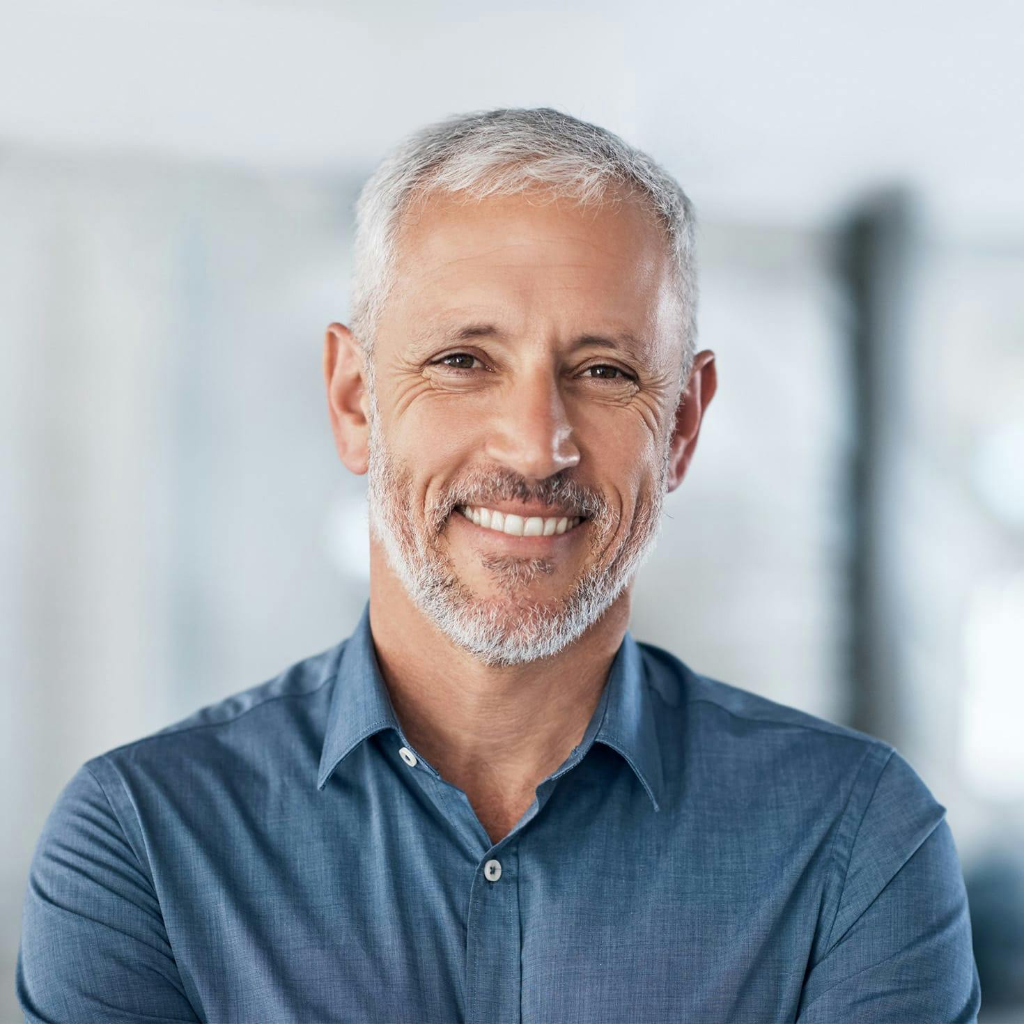 smiling man leaning over with his hands on his knees
