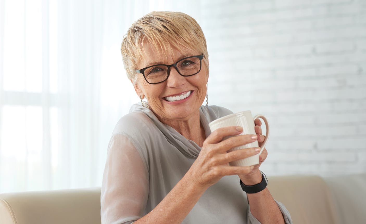 smiling man leaning against a wall