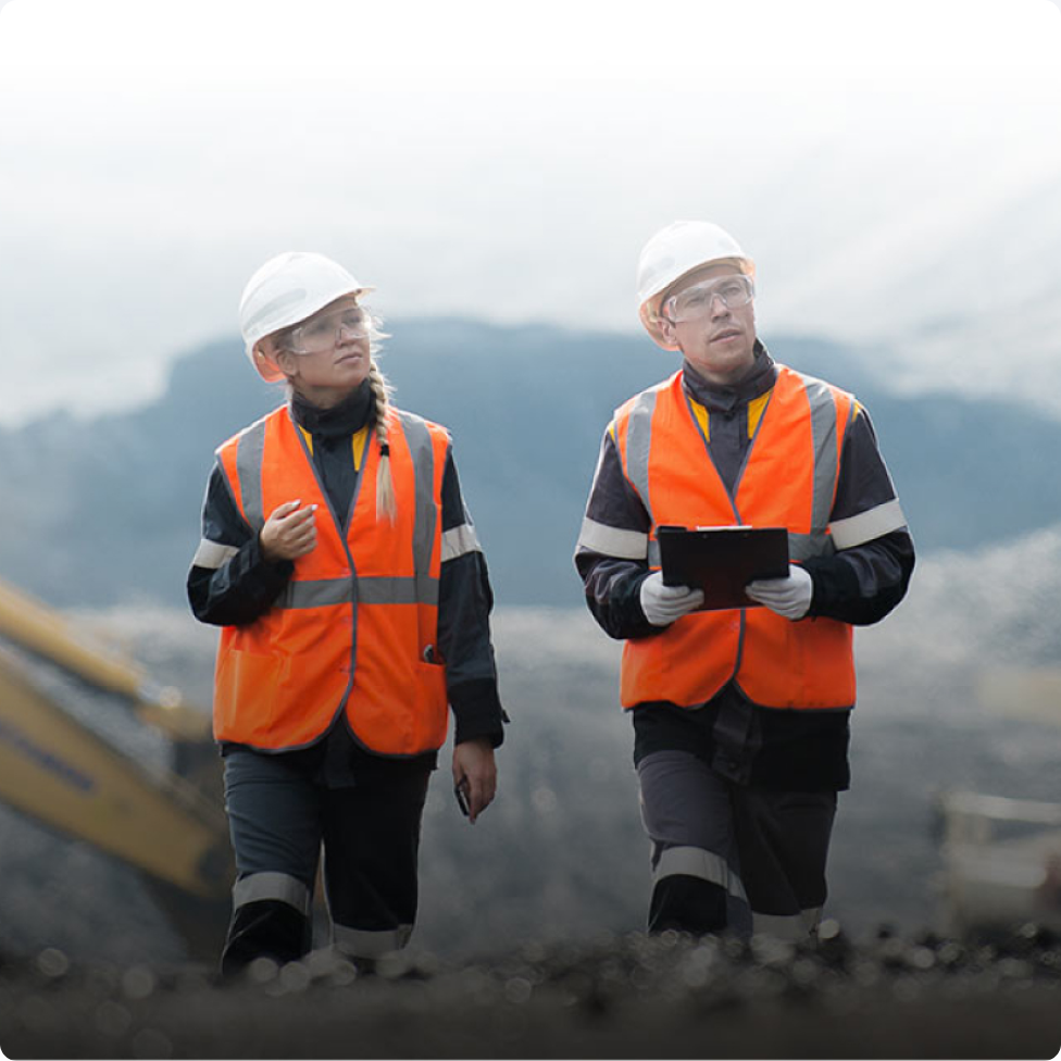 2 people wearing hard hat and hi-vis vest