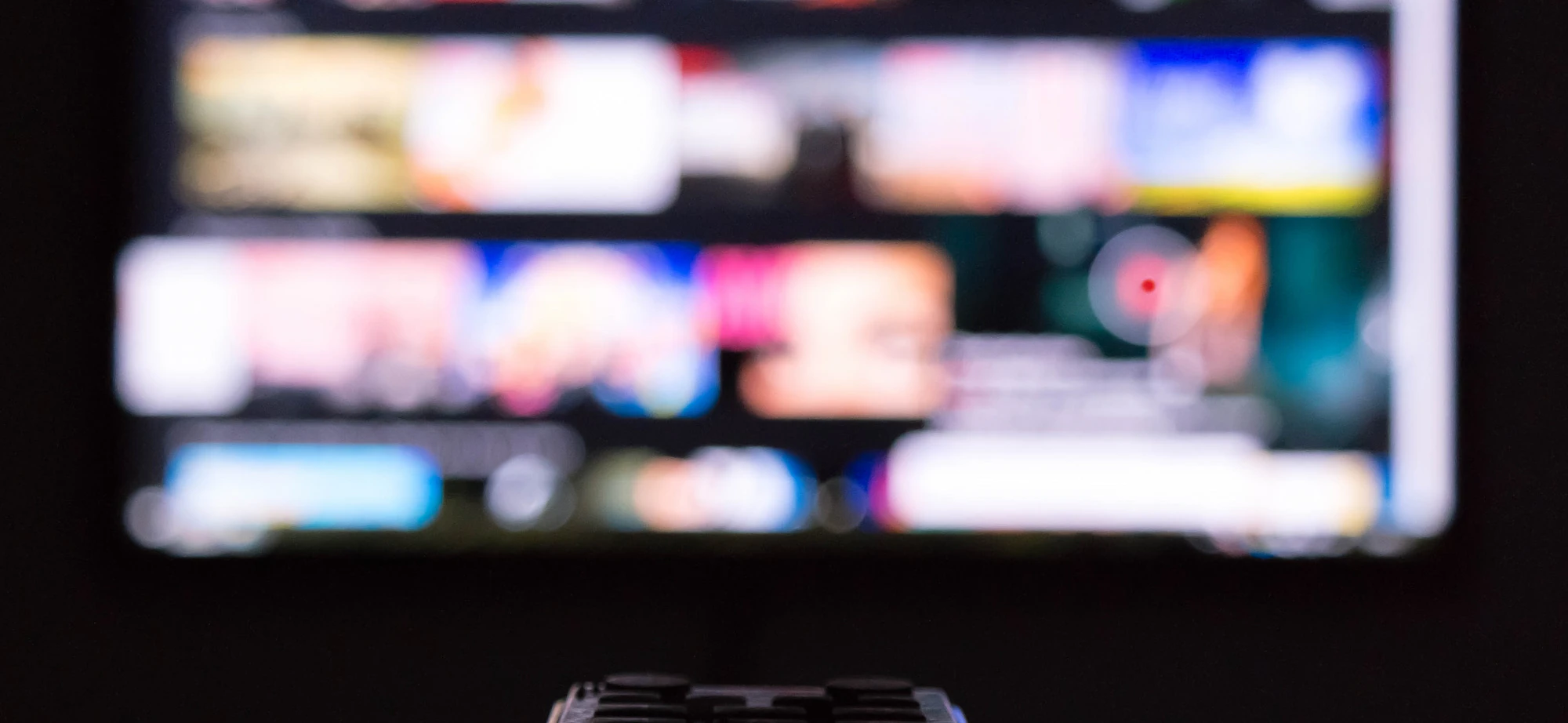 Person holding a remote and pointing it at the TV