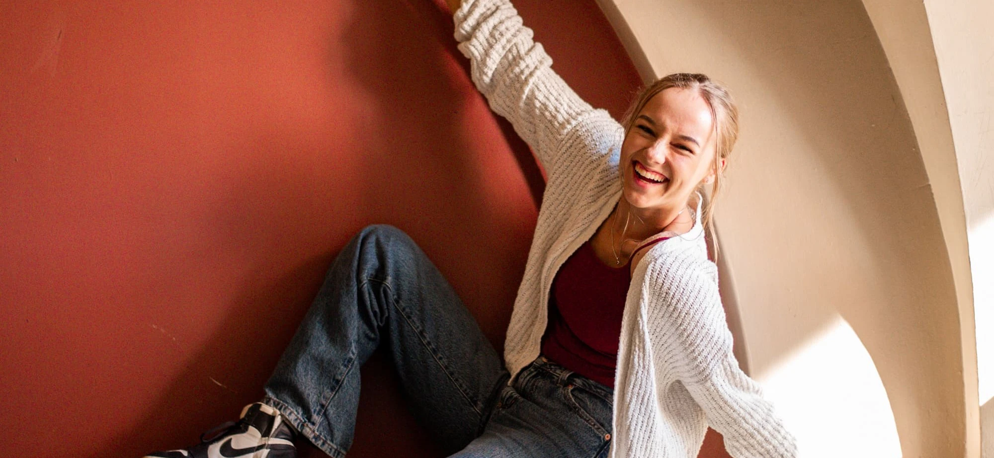 Girl smiling sitting in an alcove