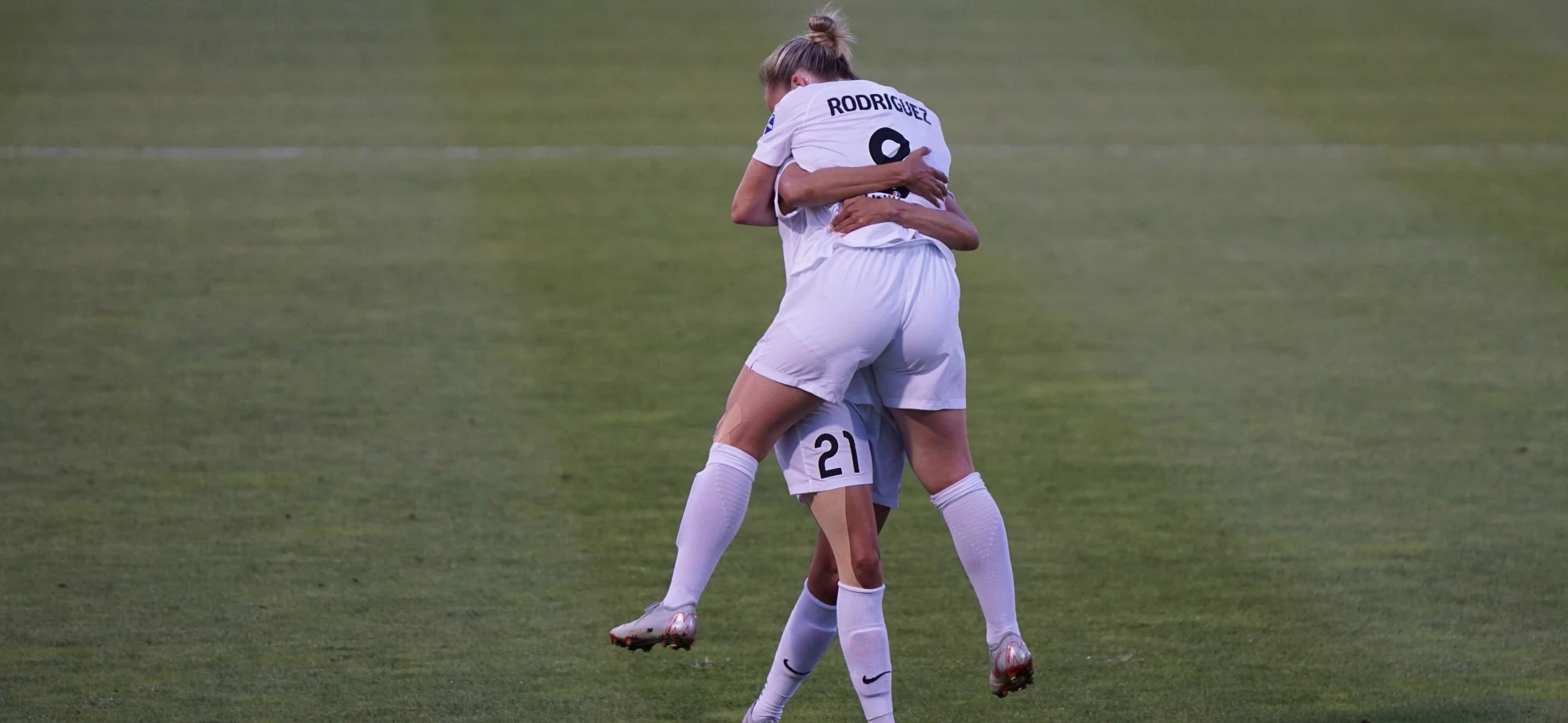 Two women celebrating playing football