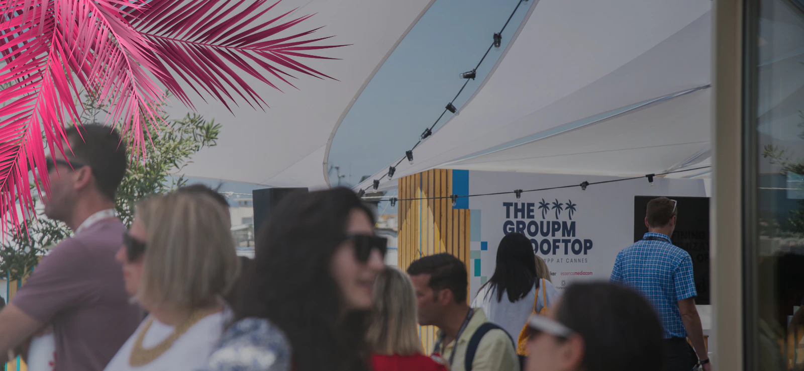 People talking and networking at the GroupM rooftop in Cannes