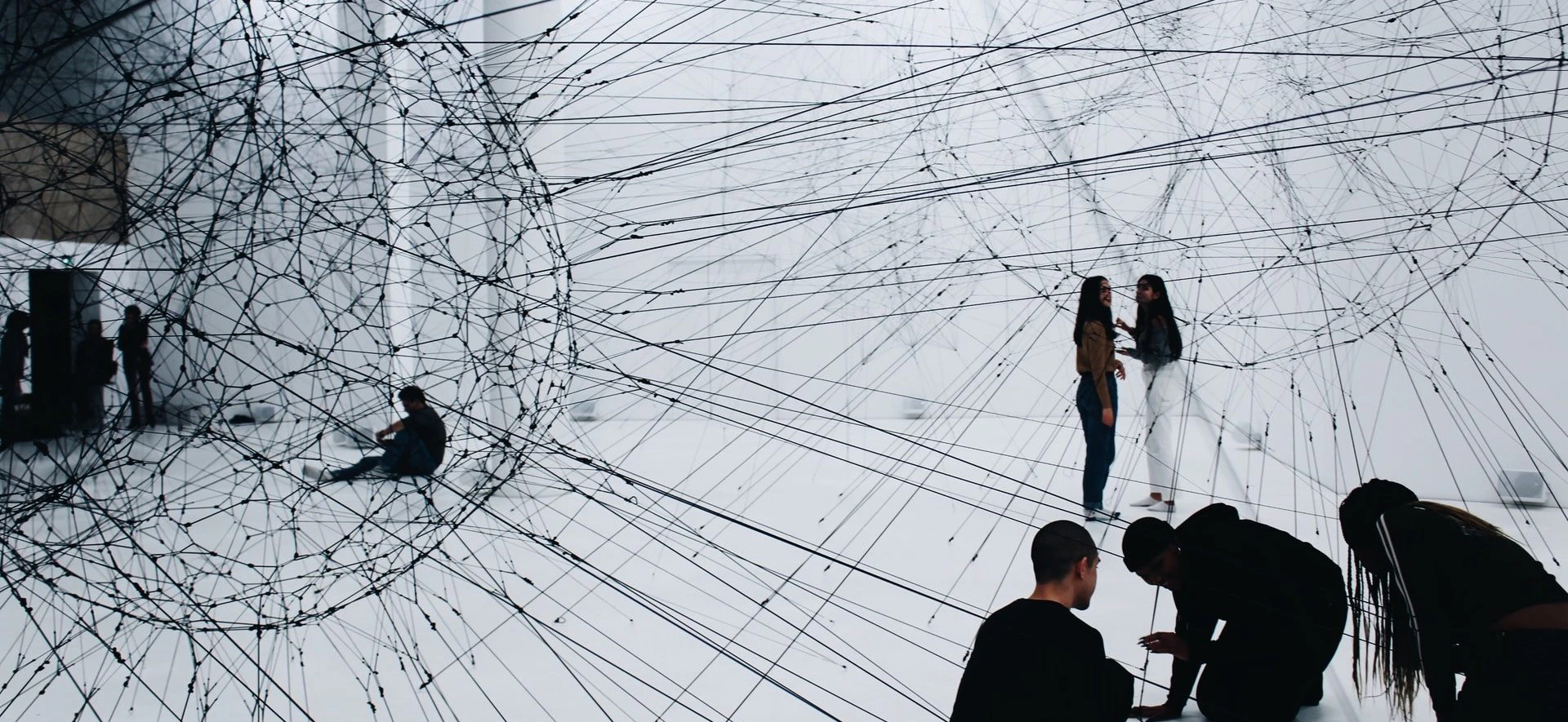 People sitting and standing with inter connecting lines