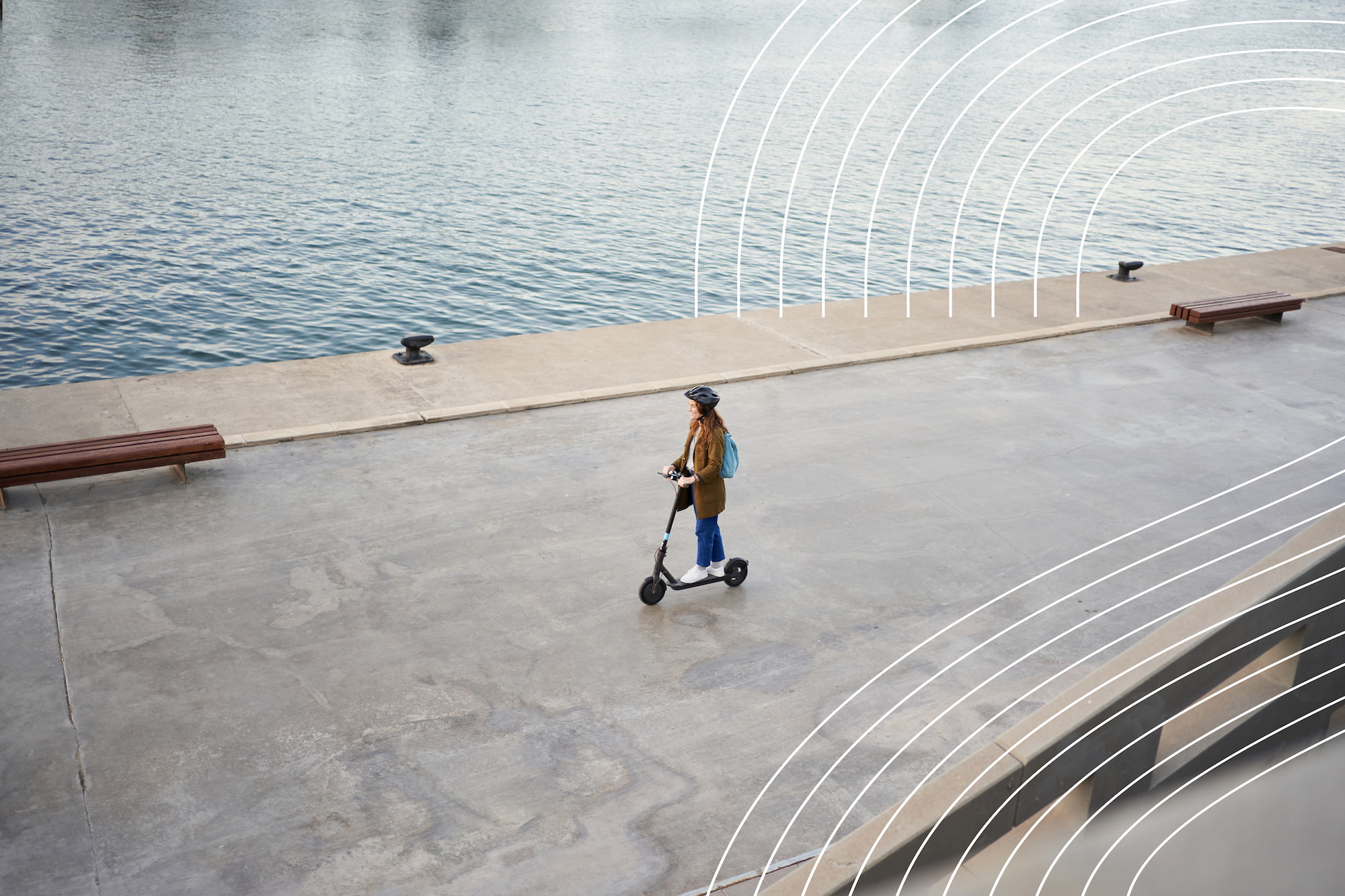 Image of a woman on a scooter next to a river