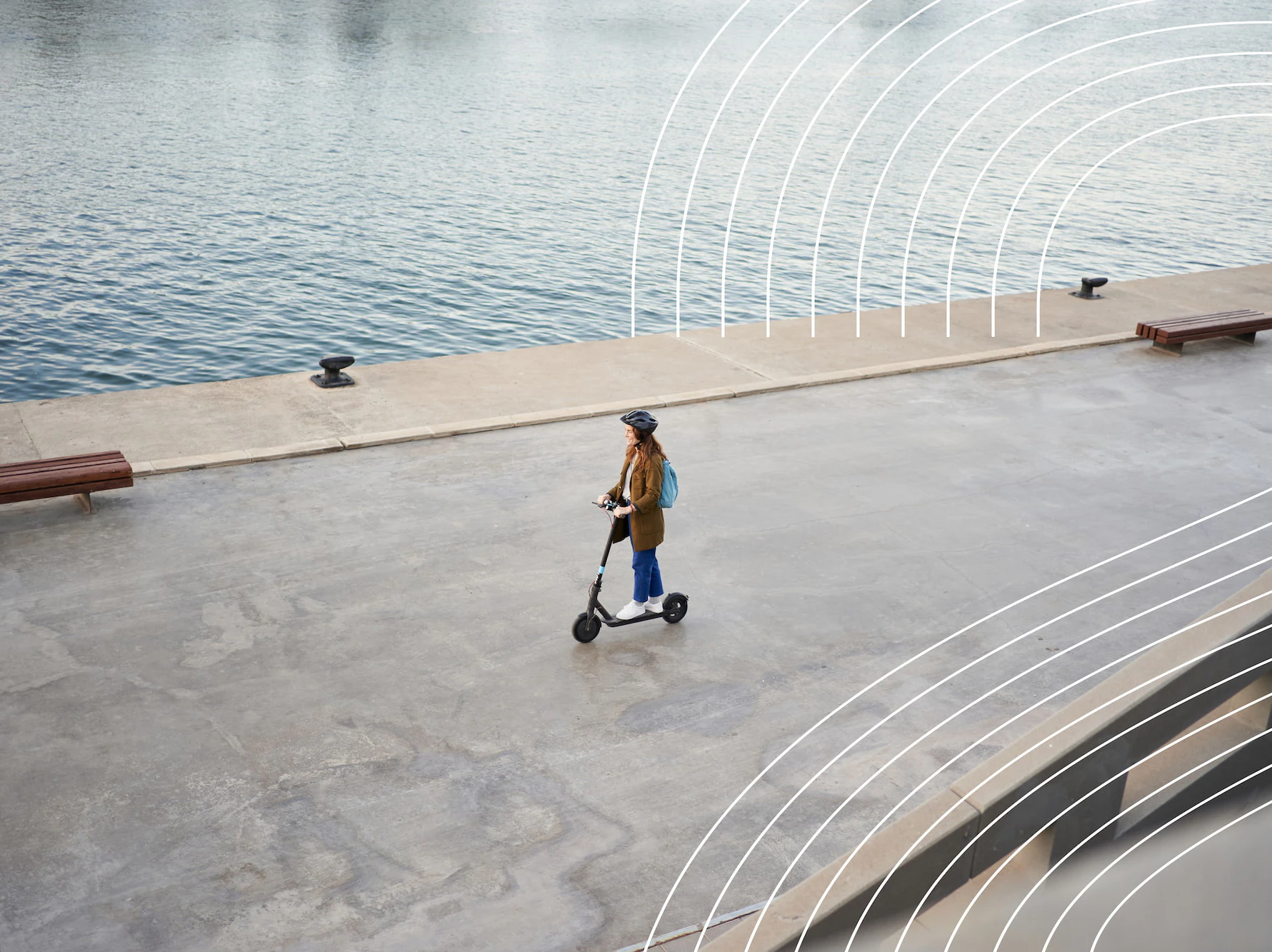Image of a woman on a scooter next to a river