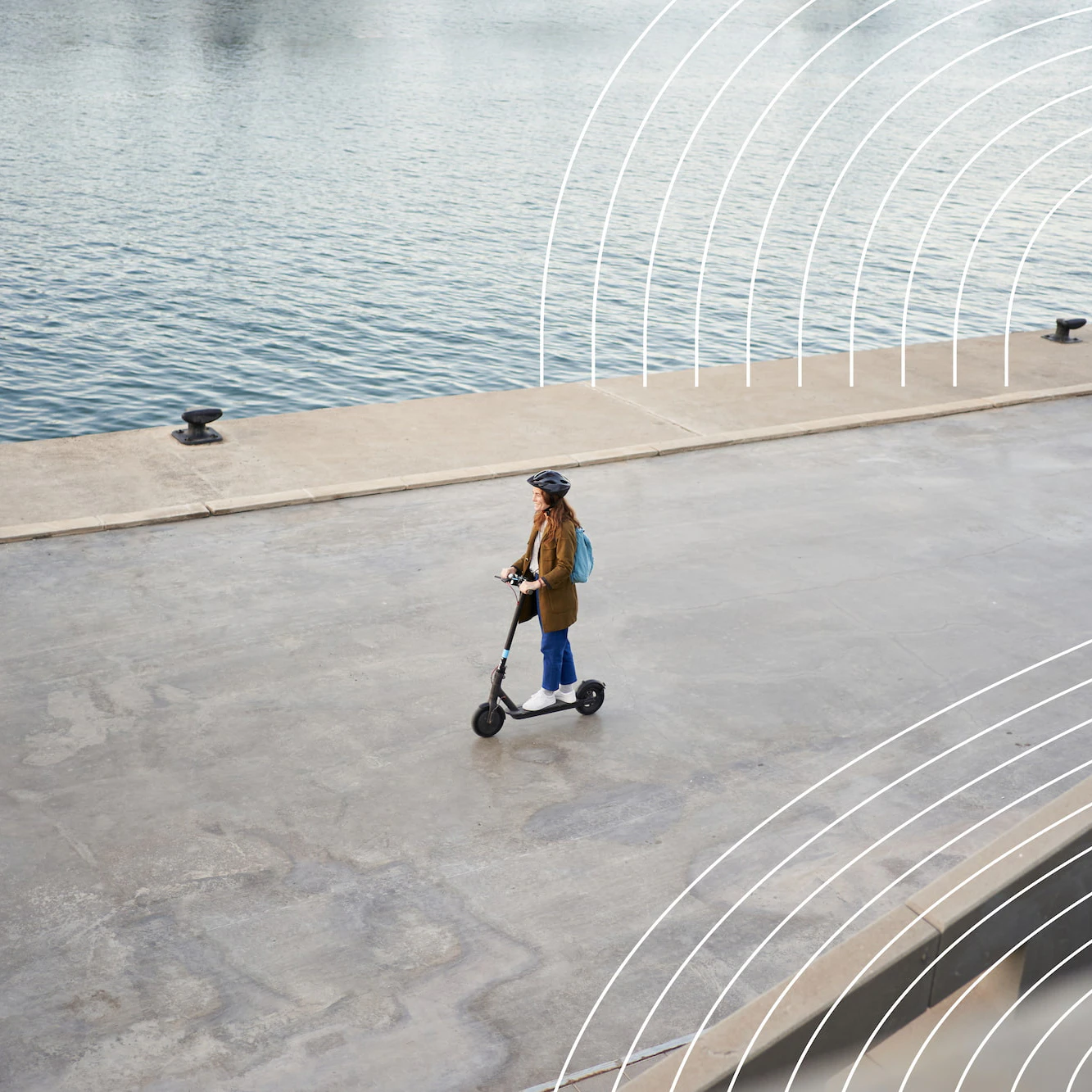Image of a woman on a scooter next to a river