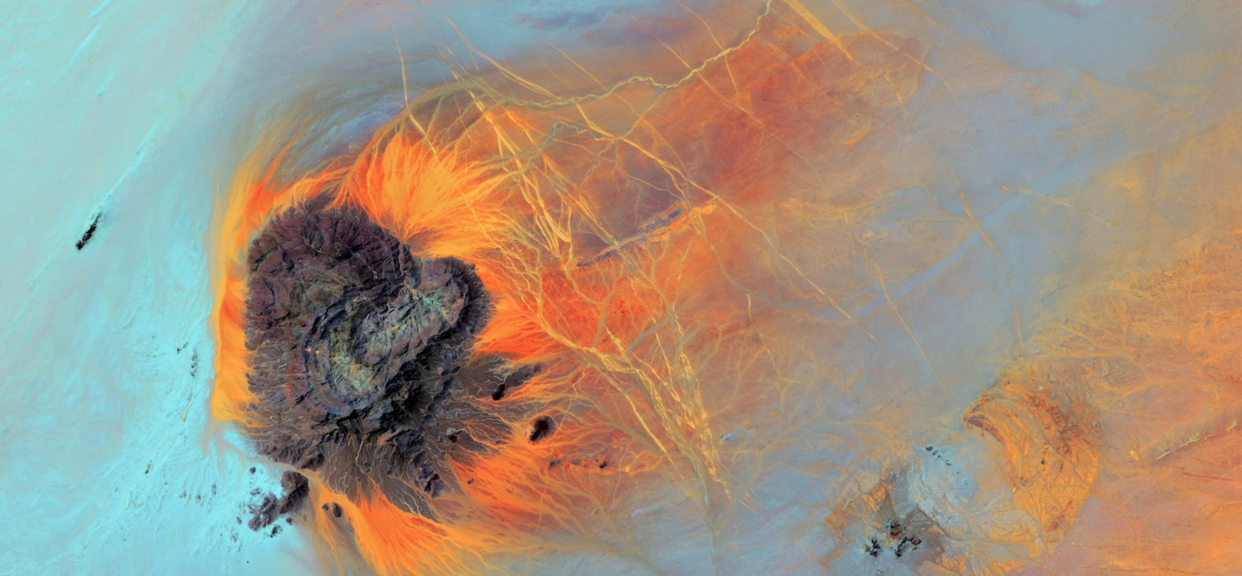 Abstract aerial landscape image with colourful rock formations of blue, orange and purple