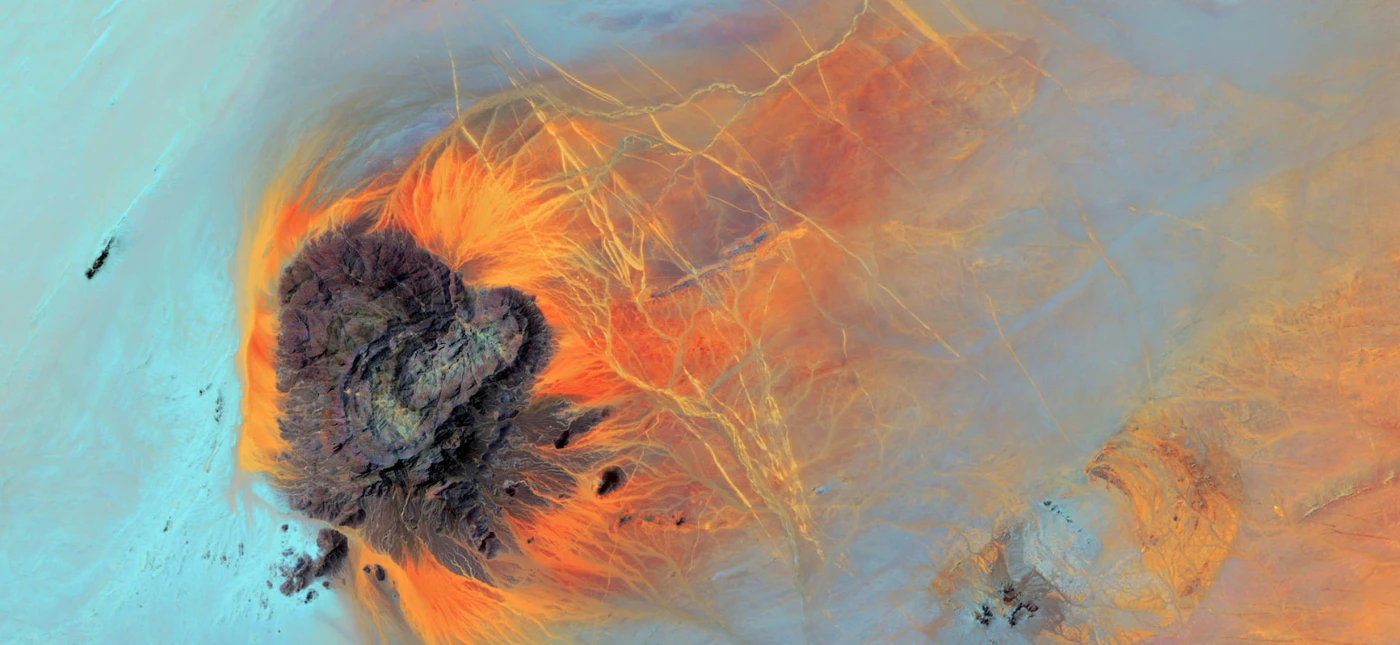 Abstract aerial landscape image with colourful rock formations of blue, orange and purple