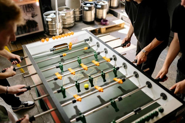 men playing foosball in a man cave