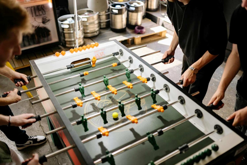 men playing foosball in a man cave