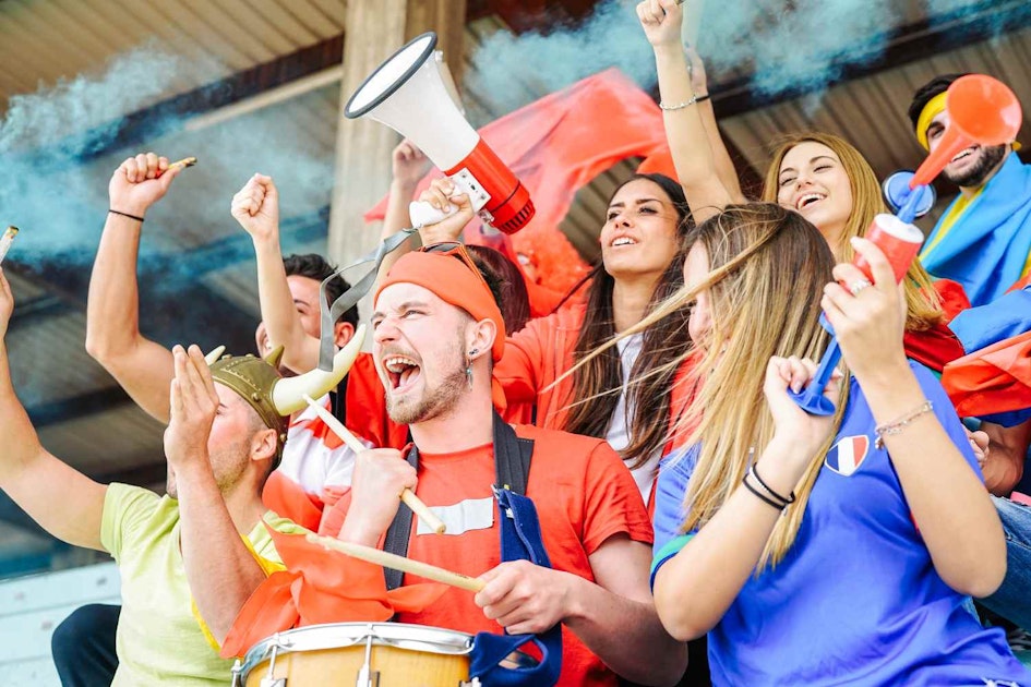 Football supporter fans watching world soccer match at stadium