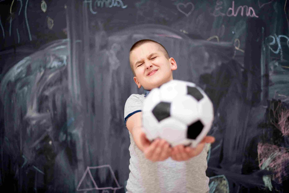 happy boy holding a soccer ball