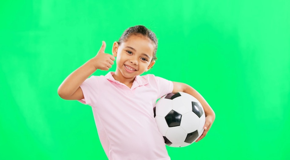 Happy Girl with Soccer Ball on Bright Green Background
