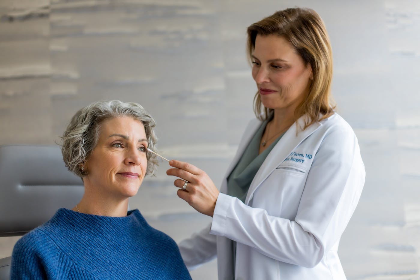 doctor pointing to client's eyelid with q-tip
