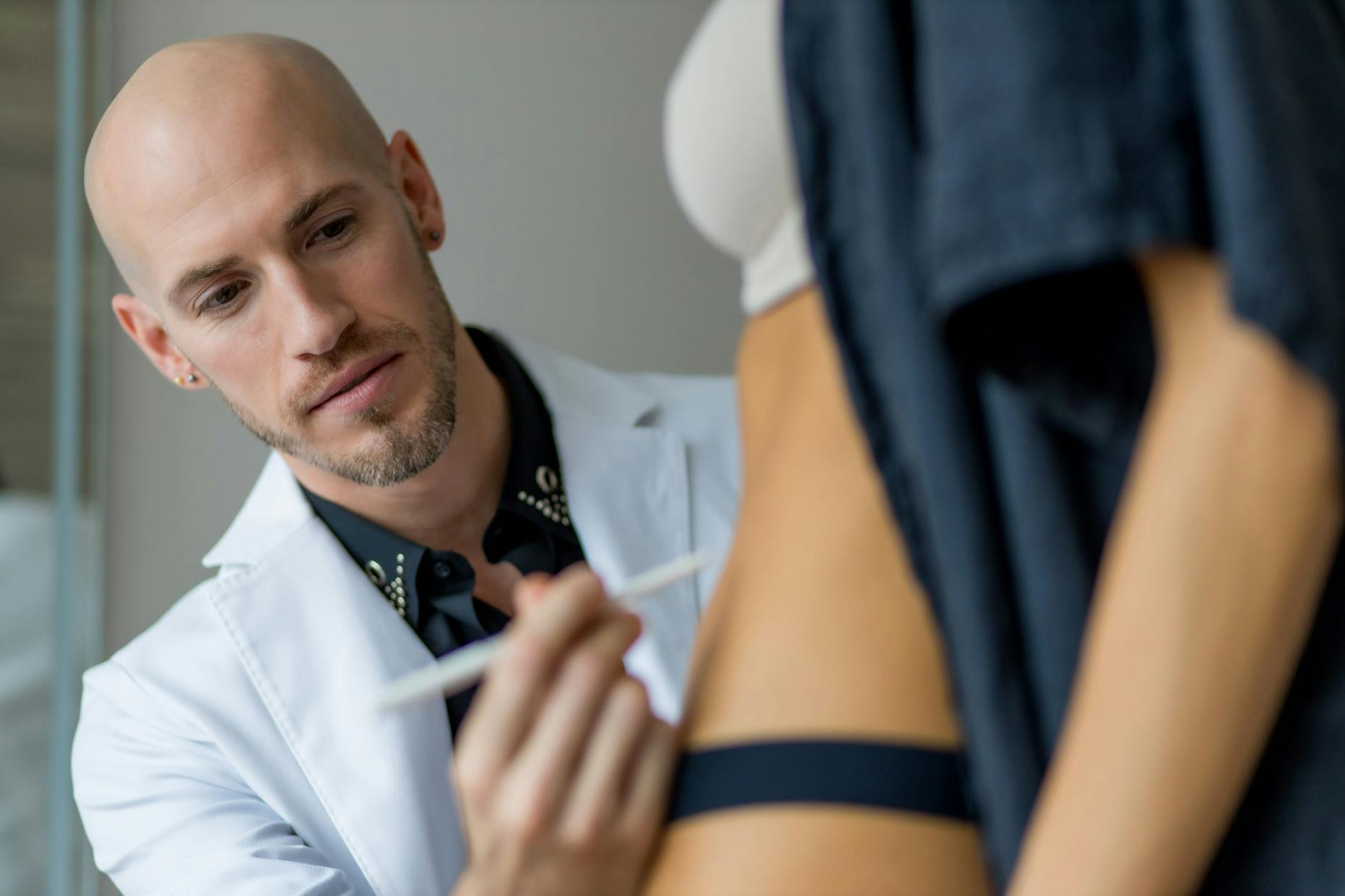 doctor marking client's body with pen