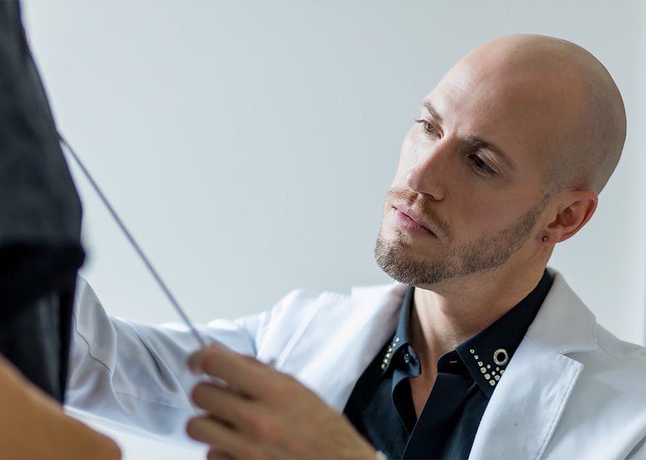 doctor measuring client's body