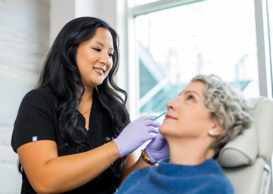 nurse injecting into client's forehead