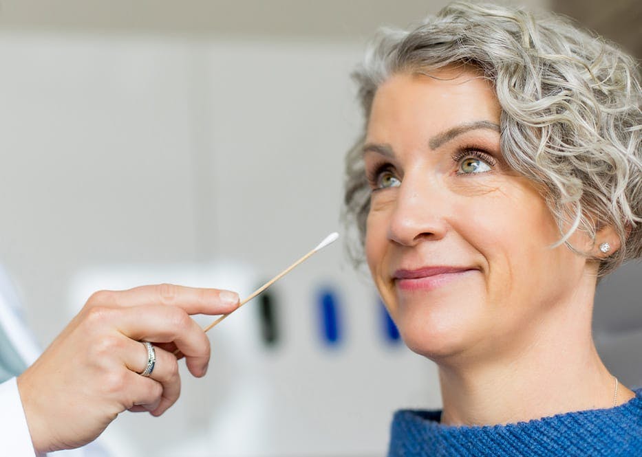 close up of client with q-tip near her eye