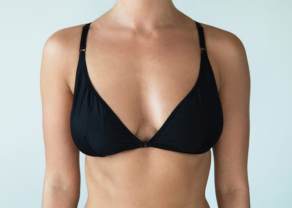 close up of woman's breast in black bra