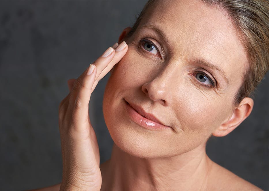 woman touching her cheek