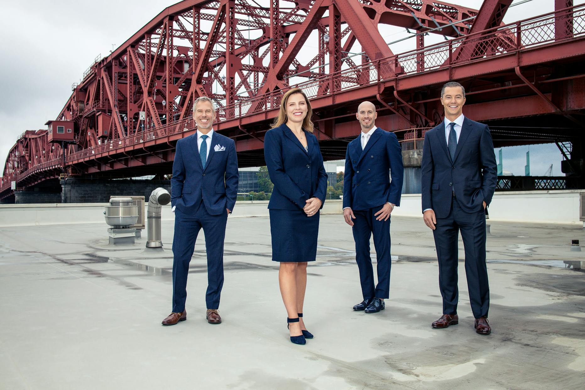doctors standing on building with red bridge in background