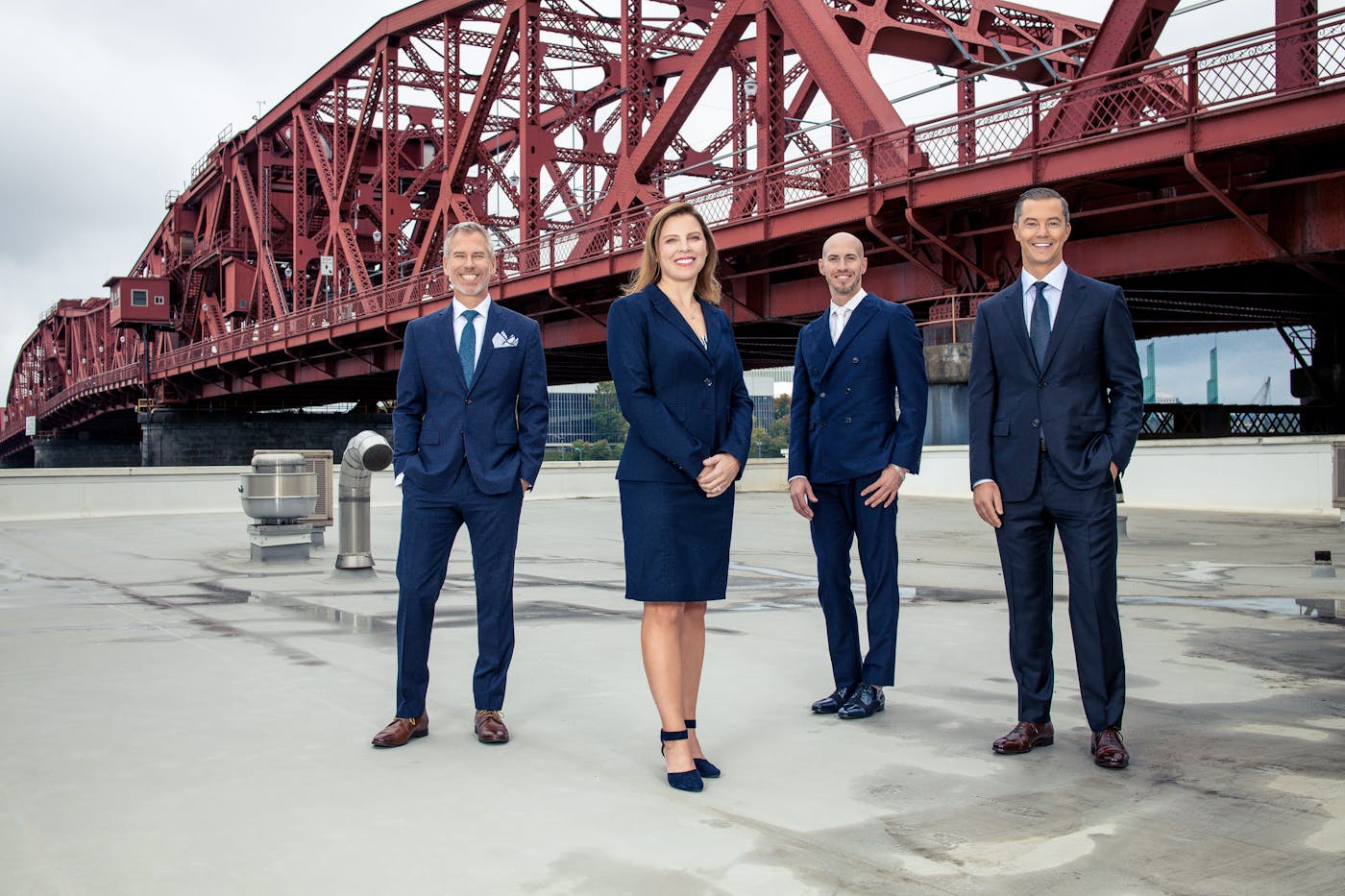 doctors standing on building with red bridge in background