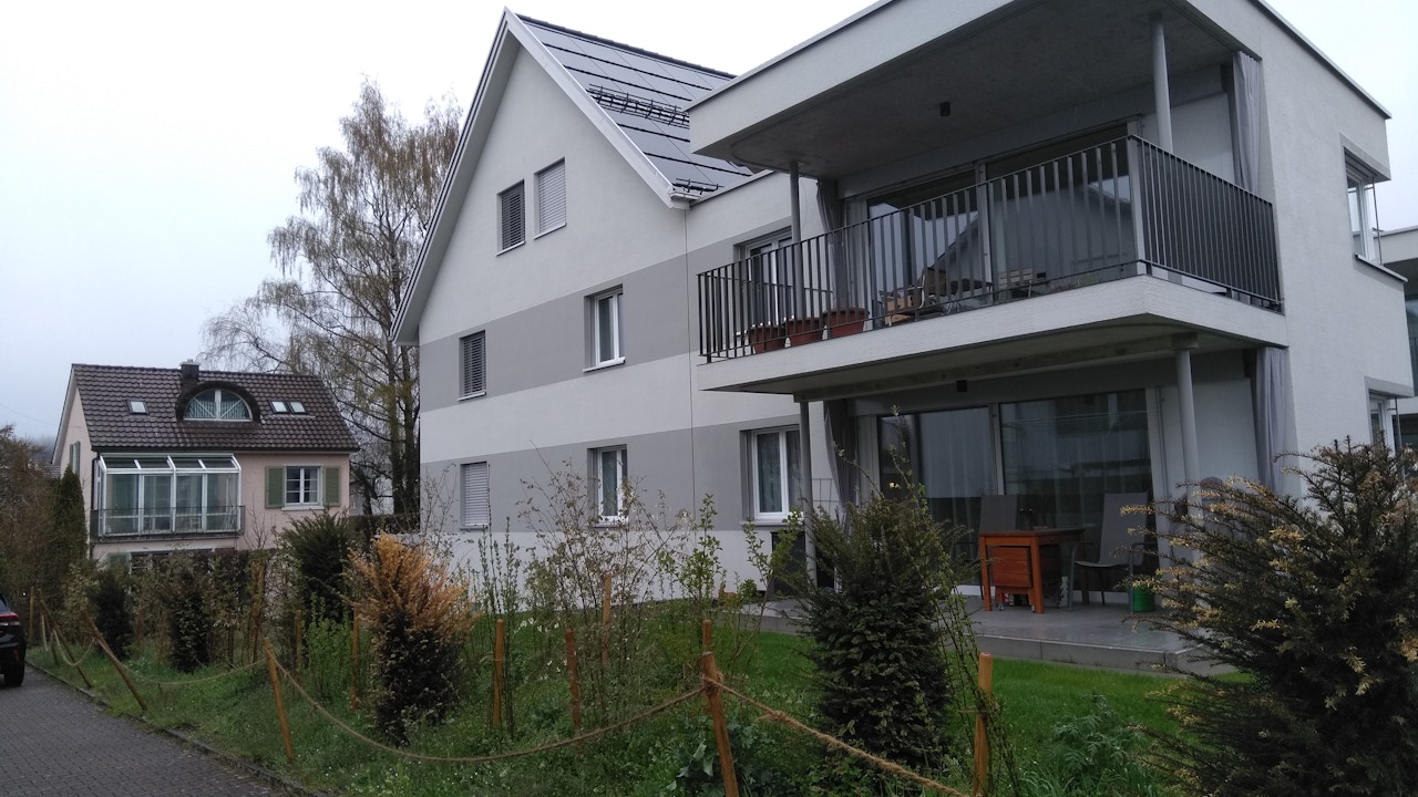 Eine naturnahe Hecke umschliesst das Mehrfamilienhaus und bietet Lebensraum für Tiere.