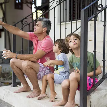 family on steps of home