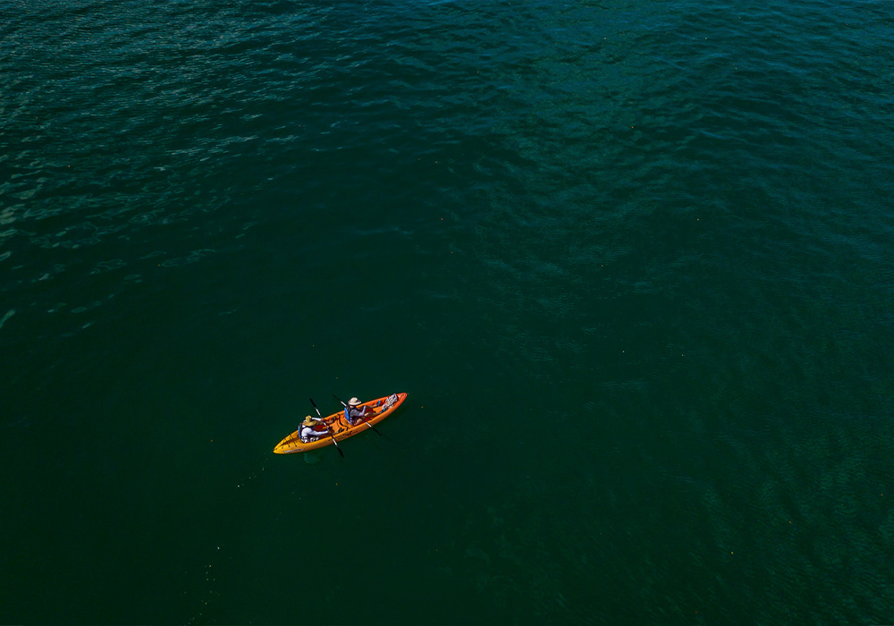two people in a kayak in the ocean