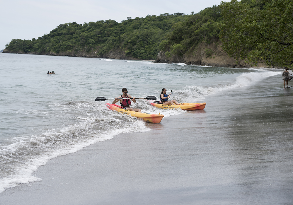 two kayakers coming ashore